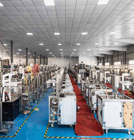 Rexpack manufacturing facility floor in Hyderabad with rows of stainless steel packaging machines
